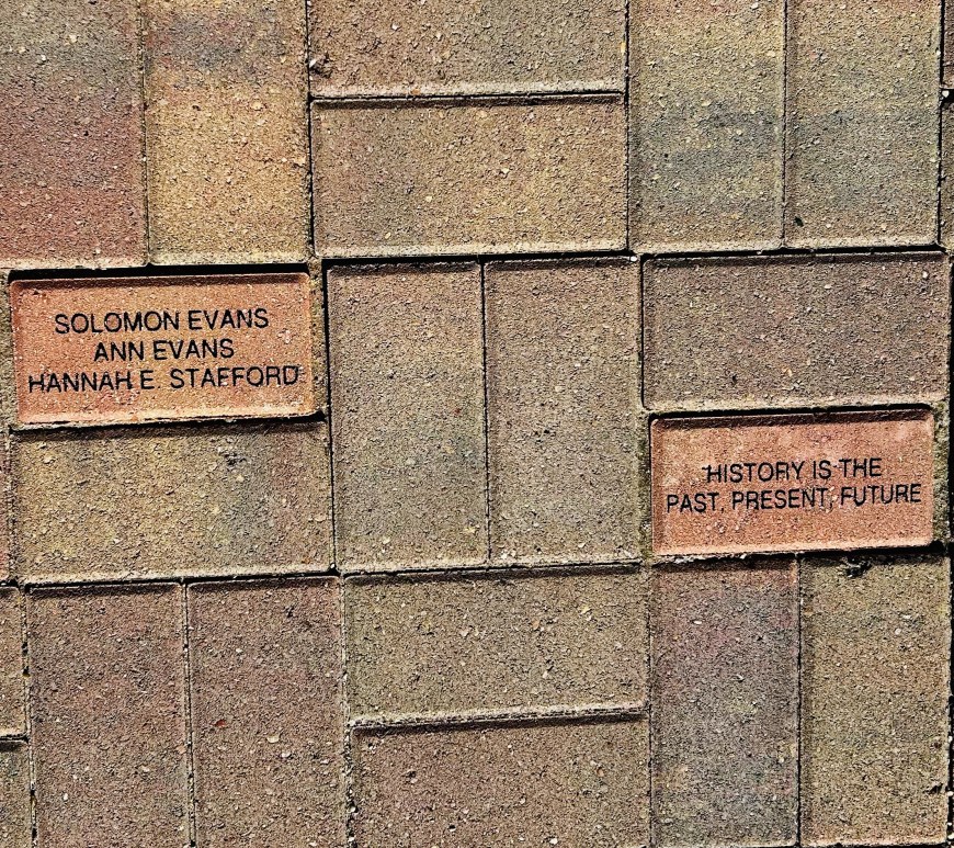 Paving stones just outside the Blue Earth Country Historical Society entrance. One is inscribed with the names Solomon Evans, Ann Evans, and Hannah E. Stafford. The other with the saying "History is the past, present, future.